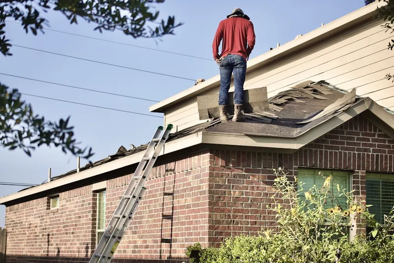 Professional roofer working on a residential roof in Fig Garden Loop